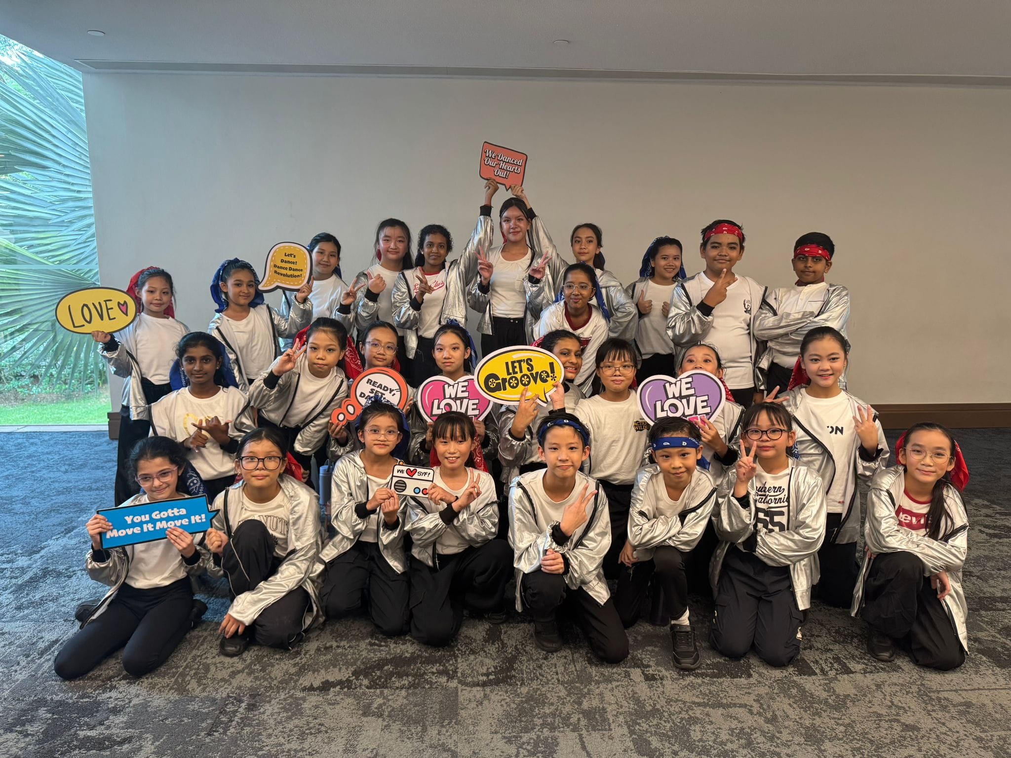 The modern dance performance group posing for a photo after performing